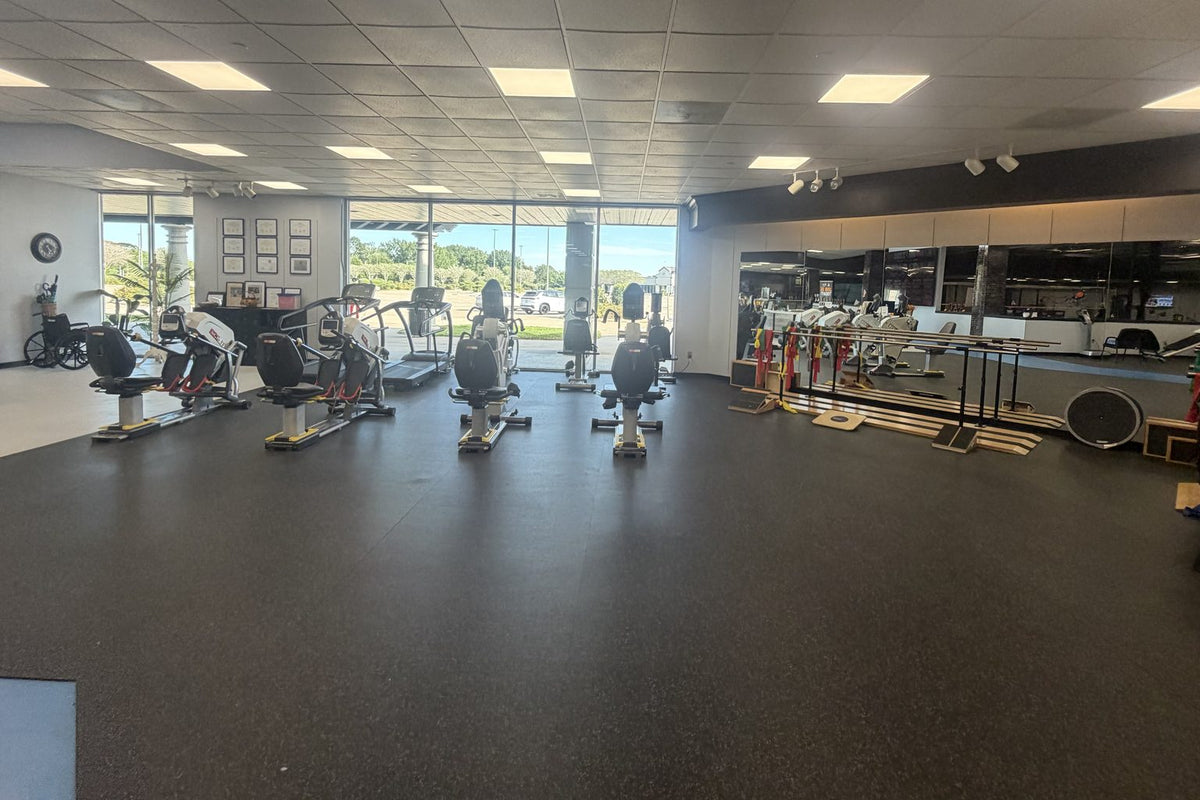 Wellness gym floor with bikes, ellipticals and parallel bars